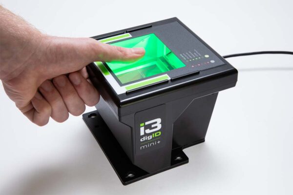A photo of a digID mini+ in use, scanning a thumb
