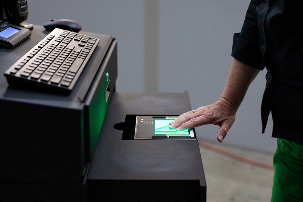 An image of a person using a digID mini+ in a kiosk